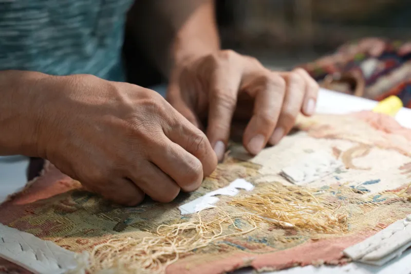 Woven in Miniature: The Fiber Artists Encoding Entire Mythologies Into Tapestries No Larger Than a Postage Stamp